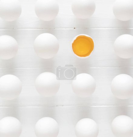 Photo for White raw eggs rows with one yolk on a white wooden table - Royalty Free Image