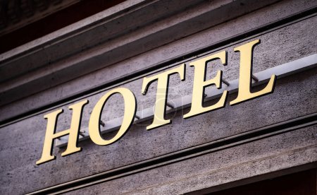 Hotel metal sign on old building facade for tourists. Travel accommodation for night staying reservation-stock-photo