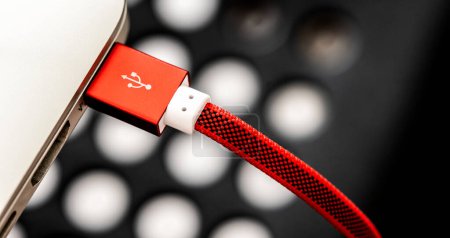 Photo for Red USB connected with laptop closeup. Plug micro cable for mobile devices in macro view - Royalty Free Image