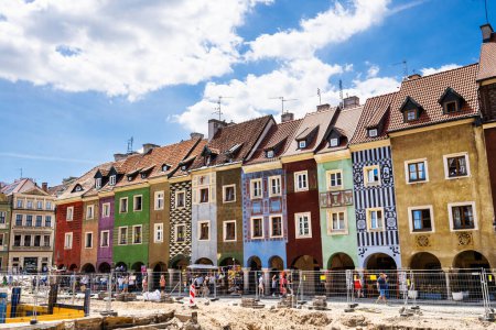 Photo for Poznan, Poland - 05 July 2022: Old Market Stary Rynek square with small colorful houses, tourists and old Town Hall in Poznan, Poland. Square under reconstruction. - Royalty Free Image