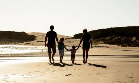 Photo for Happy family with children silhouette at sea beach sunset - Royalty Free Image