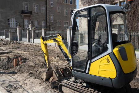 Photo for Construction Excavator Performs Road Repair Work On Street - Royalty Free Image