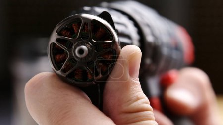 Photo for Professional assembling fpv DIY drone. Tightening a motor screws by screwdriver, close up view - Royalty Free Image