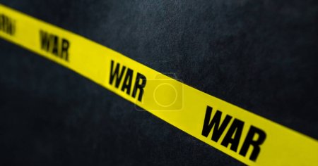 Foto de Raya de cinta amarilla de advertencia con texto de guerra como advertencia Detenga el conflicto militar. Concepto de invasión, peligro y verdad - Imagen libre de derechos