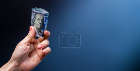 Photo for Hand holding dollar USA banknotes. with portrait of president. American currency in cash - Royalty Free Image