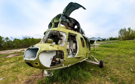 Téléchargez les photos : Abandoned soviet union helicopter with camouflage color cabin at the airfield - en image libre de droit