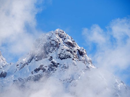 Nursultan Peak, alter Name Pioneer Peak. Ein Gipfel im Tien-Shan-Gebirge nahe der Stadt Almaty. Der schneebedeckte Gipfel ist nach starkem Schneefall in eine leichte Wolke gehüllt