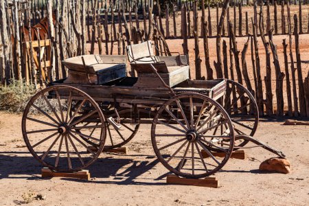 The frame and wheels of an old wagon displayed in the desert of the American southwest at Pipe Springs National Monument, Arizona.
