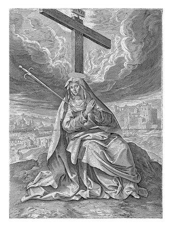 Foto de María como Mater Dolorosa, Antonie Wierix (II), después de Maerten de Vos, 1584 María se sienta con una espada en el pecho al pie de la cruz vacía. Rayos brillan en ella desde el cielo. - Imagen libre de derechos