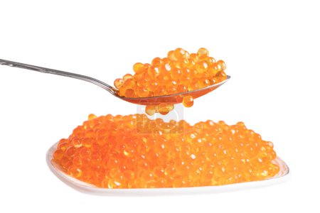 Photo for Red caviar in the ceramic plate and silver spoon isolated on a white background. Trout or salmom caviar close up. Macro shot. - Royalty Free Image