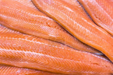 Trout fish fillet texture background. Fresh fillet wild salmon pattern. Fresh whole fillet surface