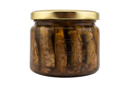Sprats fish in a glass jar isolated on a white background with clipping path. Top view. Sprats in a glass can with oil. Smoked canned sprats isolated