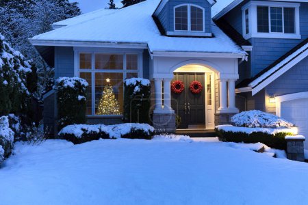 Photo for Close up view of residential home decorated for Christmas and New Year holidays with fresh blanket of snow - Royalty Free Image