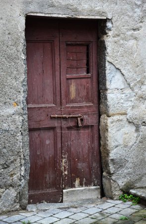 Photo for Old wooden door of a house in rural areas of Italy - Royalty Free Image