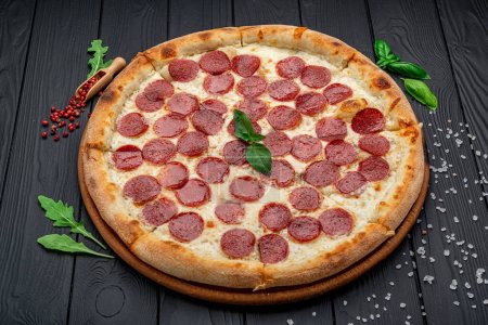 Foto de Pizza casera de queso con salami, deliciosa pizza con cheddar. Comida italiana. - Imagen libre de derechos