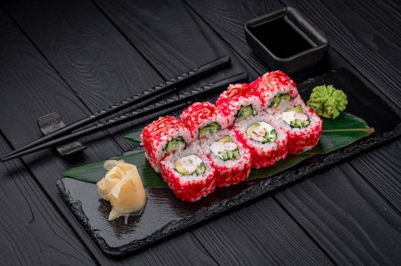 California sushi roll with crab, avocado, cucumber and tobiko caviar served. Japanese food