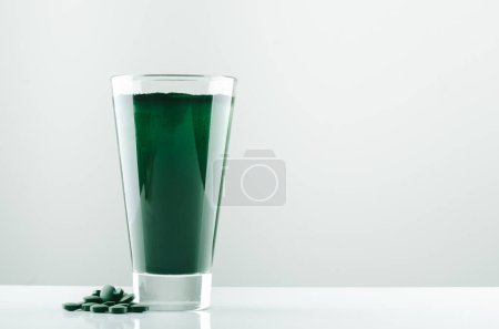 Photo for Minimalist glass with water and spirulina powder. High quality photo - Royalty Free Image