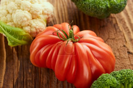 Photo for Food still life with tomato, broccoli and cauliflower on wooden table - Royalty Free Image