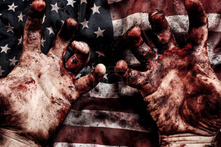 Foto de Bloody hands of soldier with flag of United States of America. War concept. Protecting of democracy - Imagen libre de derechos