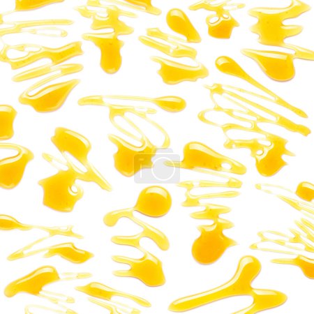 Foto de Conjunto de gotas de miel dulce aislado sobre fondo blanco - Imagen libre de derechos