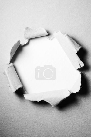 Photo for Background of torn paper with hole in the center - Royalty Free Image