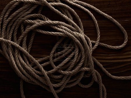 Photo for Dark vintage marine background with old hemp rope over wooden planks - Royalty Free Image