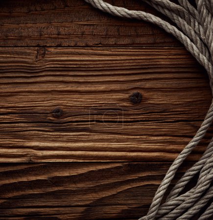 Photo for Dark vintage marine background with old hemp rope over wooden planks - Royalty Free Image