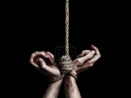 Photo for Woman's hands with bloody stains tied with a rope over black background - Royalty Free Image