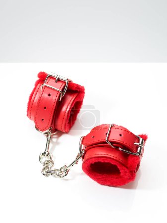 Photo for Red handcuffs for bdsm fetish role play game isolated on white background - Royalty Free Image