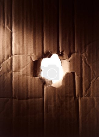 Photo for Shipment box surface texture with hole in the middle. recycle cardboard background. through the hole - Royalty Free Image