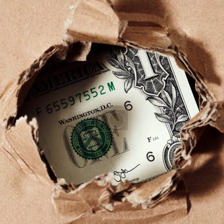 Foto de Un dólar a través del fondo del dinero del agujero de papel - Imagen libre de derechos