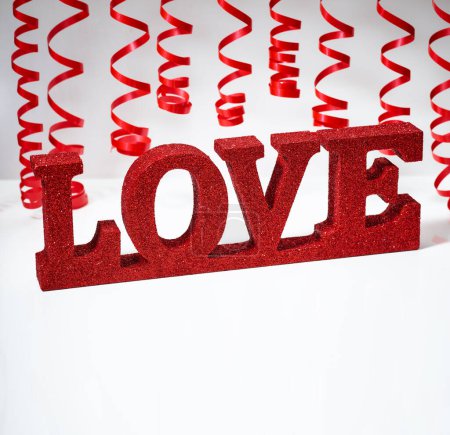 Foto de Cinta roja y palabra amor sobre fondo blanco aislado - Imagen libre de derechos