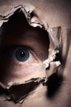 scary person looking through a hole in a box