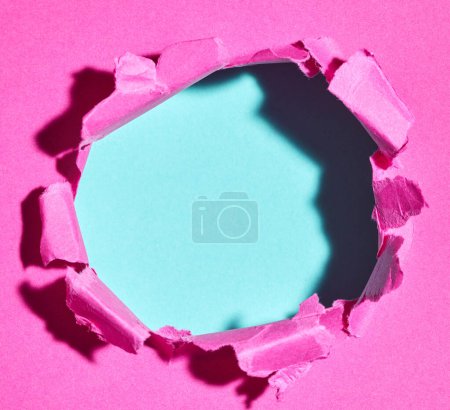 Photo for Ripped pink paper with hole in the center - Royalty Free Image