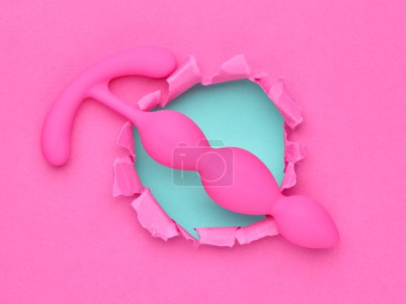 Foto de Anal plugs and dildo sex toys over pink background - Imagen libre de derechos