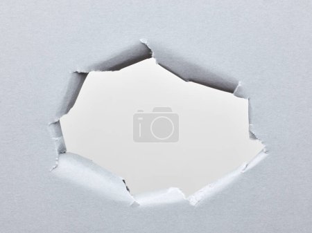 Photo for Hole in sheet of paper. ripped business paper surface background - Royalty Free Image