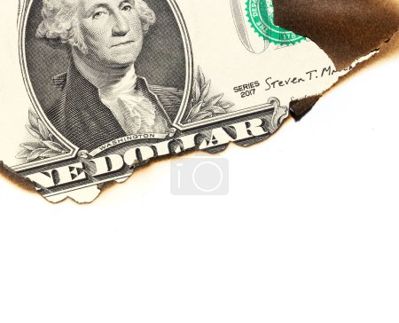 Foto de Un dólar en el agujero quemado de papel aislado sobre fondo blanco - Imagen libre de derechos