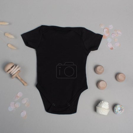 Photo for Black new baby bodysuit on grey background. Pastel color. Empty place for text or logo on apparel. Mock up template. Baby short sleeve mockup - Royalty Free Image