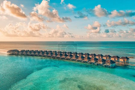 Photo for Wooden pier with bungalows in sea - Royalty Free Image