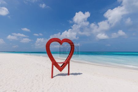Photo for Red heart shaped frame for photo on the beach - Royalty Free Image