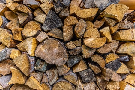 Photo for Dry chopped firewood logs. Wooden pile texture. Abstract autumn winter countryside, textured firewood background of chopped wood for kindling and heating the house, stacked woodpile - Royalty Free Image