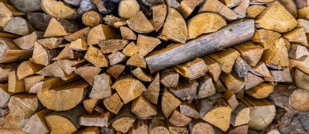 Photo for Dry chopped firewood logs. Wooden pile texture. Abstract autumn winter countryside, textured firewood background of chopped wood for kindling and heating the house, stacked woodpile - Royalty Free Image