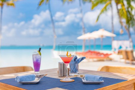 Photo for Luxury resort hotel poolside, outdoor restaurant on the beach, ocean and sky, tropical island cafe, tables, food. Summer vacation or holiday, family travel. Palm trees, infinity pool, cocktails, relax - Royalty Free Image