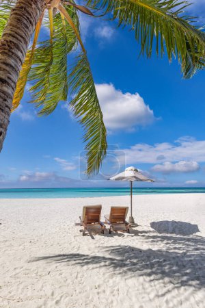 Photo for Love couple amazing beach. Sunny umbrella and lounge chairs beds close to sea under palm leaves. Summer relax coast landscape, leisure inspire honeymoon vacation, romantic lifestyle. Freedom travel - Royalty Free Image