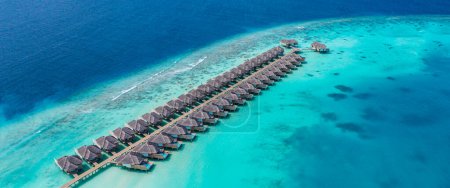 Photo for Picturesque aerial view of luxury tropical island resort water villas. - Royalty Free Image