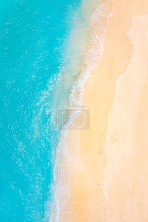 Photo for Stunning top view on coast waves on beach aerial view. Calm crystal clear water. Stunning summer landscape, sunny tropical island shore. - Royalty Free Image