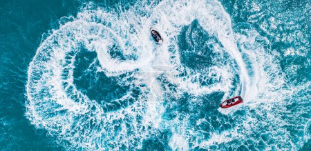 Photo for People playing with jetski in sea bay. Aerial view top view, outdoor sport recreational freedom background. Adventure fun turquoise lagoon on tropical beach. Sunny fun ocean summer vacation - Royalty Free Image
