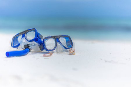 Photo for Summer sport beach activity, beach recreational concept. Diving goggles and snorkel gear on white sand near beach. Summer vacation and recreational travel adventure. Outdoor sport wellbeing freedom - Royalty Free Image