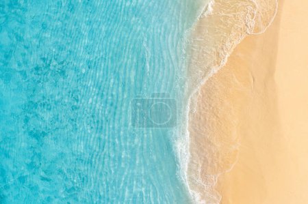 Photo for Stunning top view on coast waves on beach aerial view. Calm crystal clear water. Stunning summer landscape, sunny tropical island shore. - Royalty Free Image