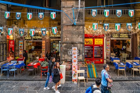 Photo for Naples, Italy - May 7, 2023: tourists in Via dei Tribunali street in the historic center of Napoli with shops and restaurants in the backgorund - Royalty Free Image